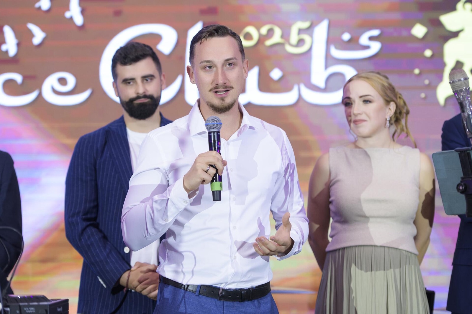 Alex Boch on stage at a business club